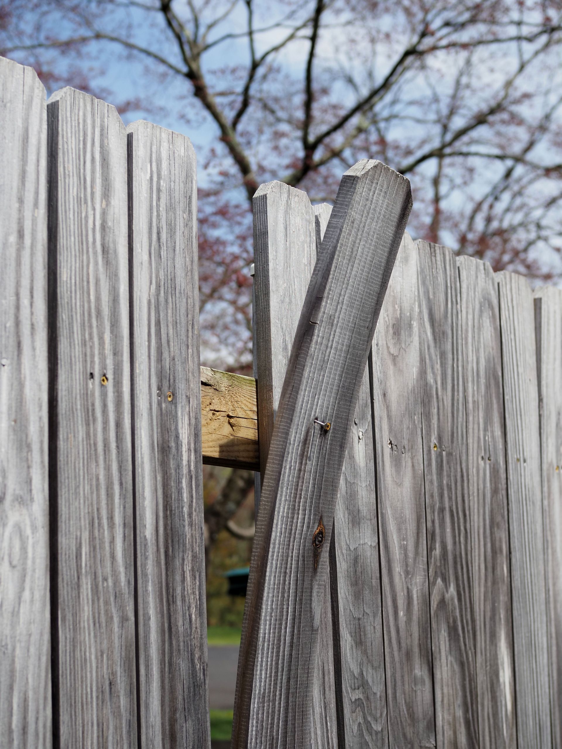 Close-up view of a weathered wooden fence against a clear sky in New Britain.